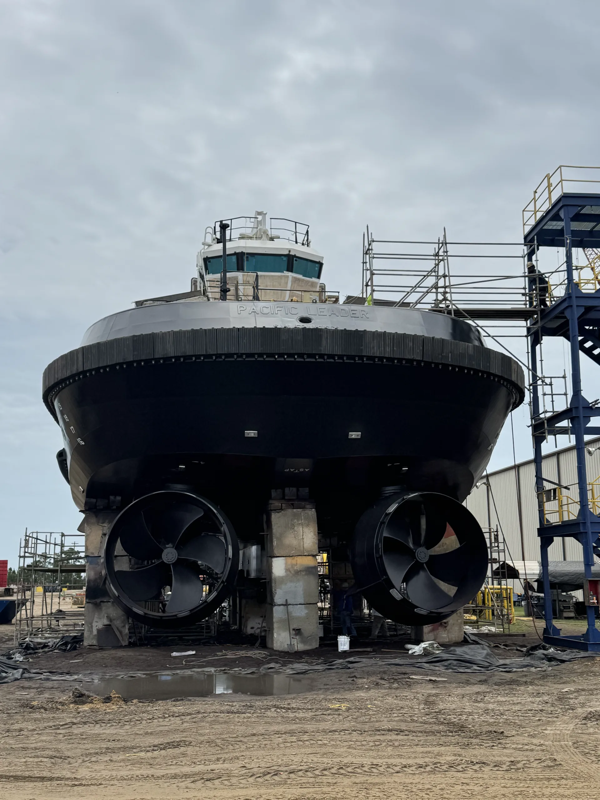 Tugboat in the yard with twin azimuth thrusters exposed